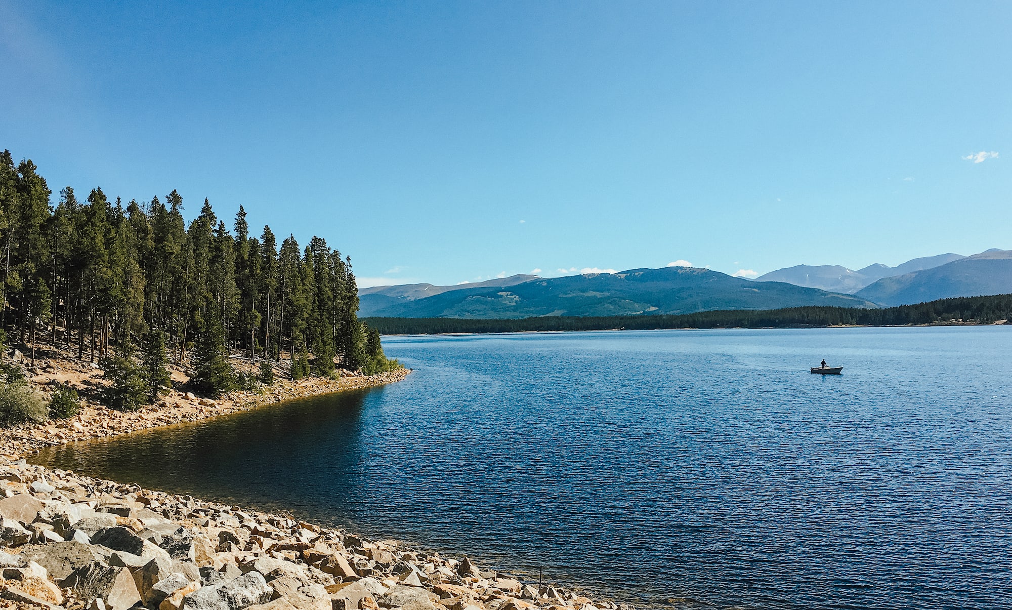 A man goes fishing on Turquoise Lake