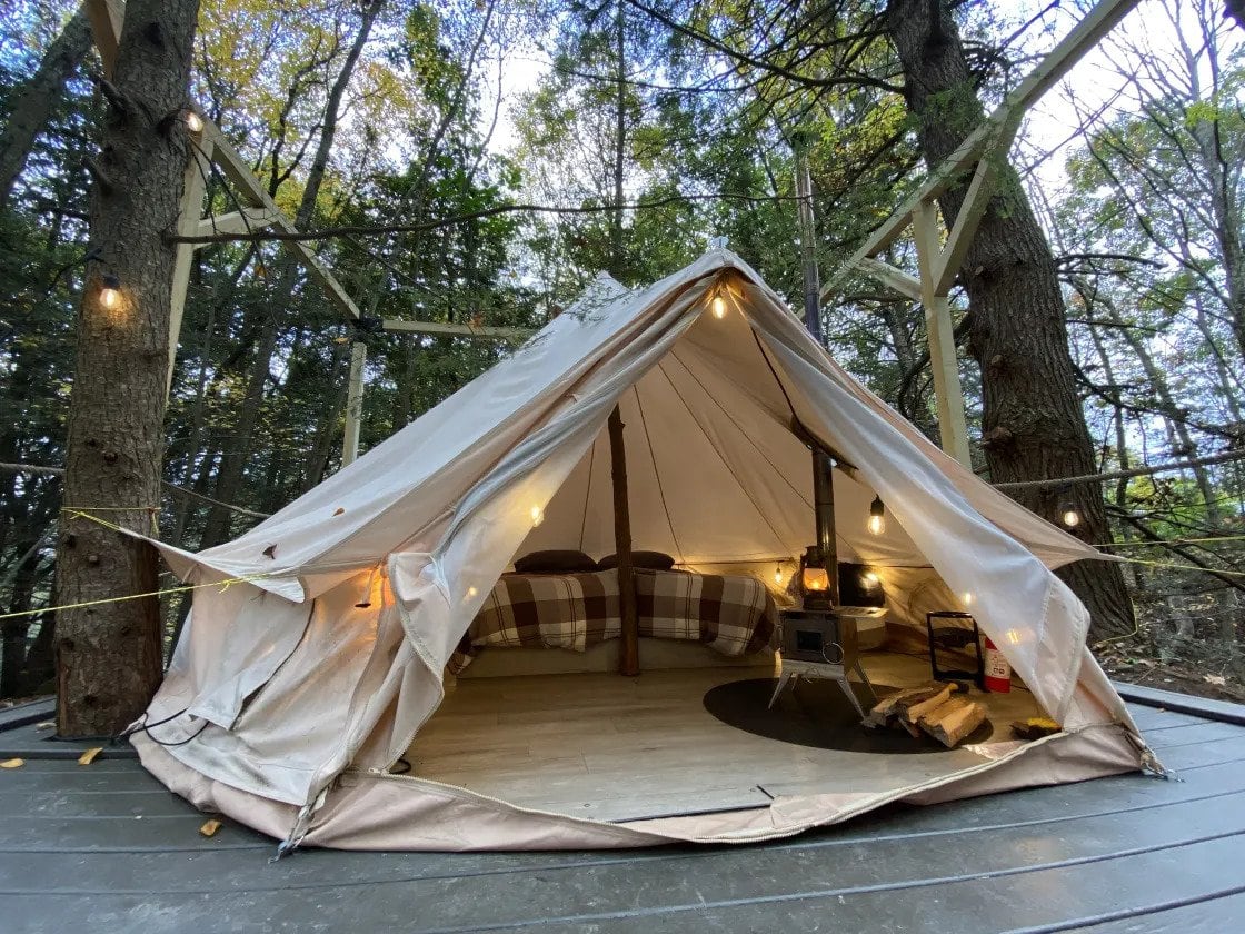 canvas tent by waterfall