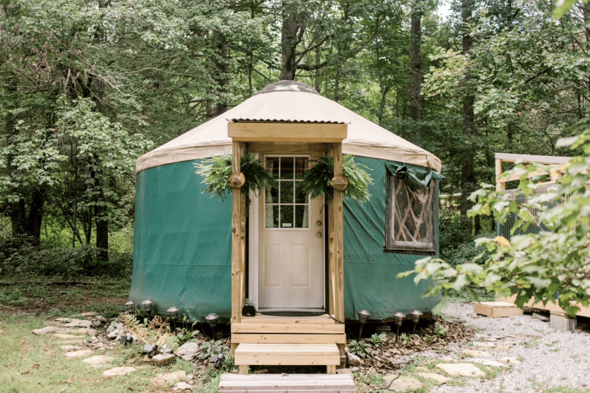A little green yurt in the woods