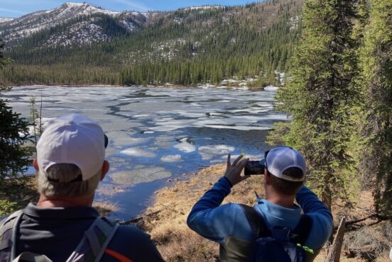 hikers look out over Triple Lakes